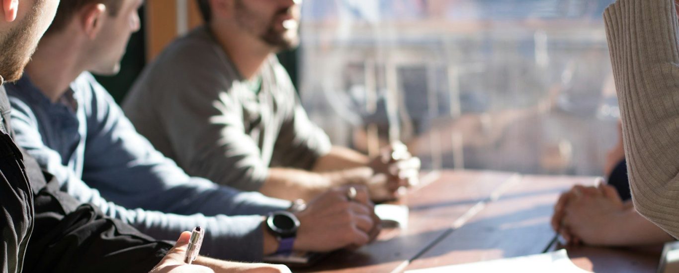 SourceArc Advisory – collaborative approach to semiconductor sourcing Team of professionals in discussion – SourceArc Advisory consulting on semiconductor sourcing and procurement strategies.
